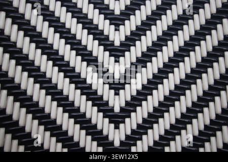 Monochrome woven texture with geometric chevron patterns. A professional high-contrast background suitable for editorial and design usage. Stock Photo
