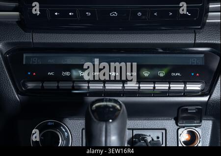 Display of a car climate control system shows temperature and function settings. The controls are designed for user operation. Stock Photo