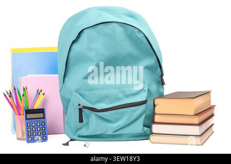 Turquoise school backpack with stacked books, notebooks, colored pencils and blue calculator on a bright white background. Stock Photo
