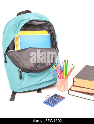 Open turquoise backpack with notebooks, colored pencils, calculator, eraser, sharpener and books on a clean white background for back to school. Stock Photo