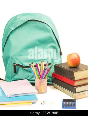 Bright white background with turquoise backpack, stack of books, apple, colored pencils, notebooks, calculator, eraser and sharpener for back to schoo Stock Photo