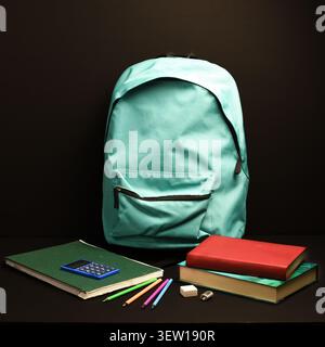Turquoise backpack with green notebook, stacked books, calculator, colored pencils, eraser and sharpener on black background, school preparation conce Stock Photo