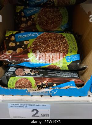 DENIA, SPAIN - January 26, 2026.Bicentury brand milk chocolate and hazelnut rice cakes are displayed on a supermarket shelf in Spain. These snacks are Stock Photo