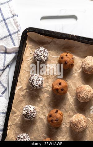 A close up of a baking sheet with rows of homemade energy balls. Stock Photo