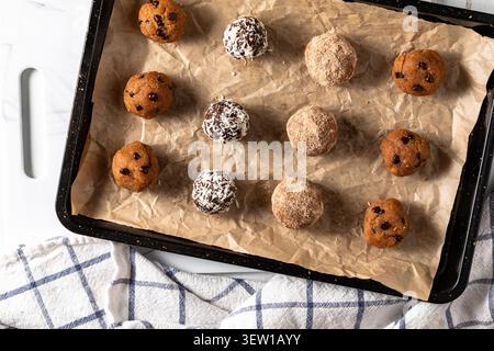 Freshly made delicious high protein energy balls on a baking sheet. Stock Photo