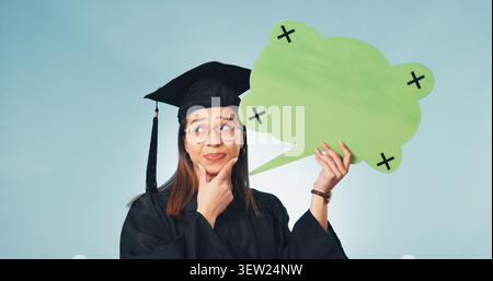 Graduation, woman and thinking in studio with speech bubble, education forum and opinion. Social media, student or word cloud space on blue background Stock Photo