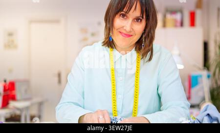 Female seamstress creating design in clothing workshop Stock Photo
