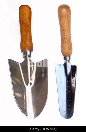 Two garden trowels with wooden handles, useful gardening digging tools, on white background Stock Photo