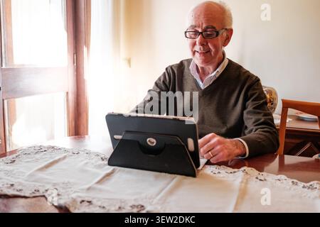 Senior man learning and enjoying digital technology at home Stock Photo