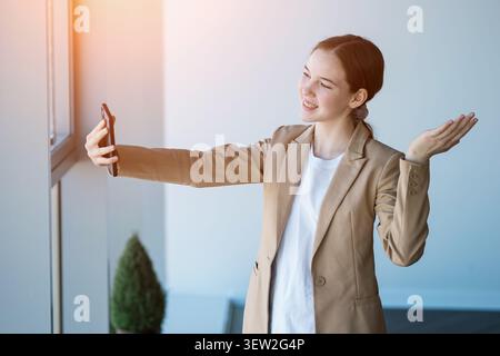 Young woman having video call using smartphone Stock Photo