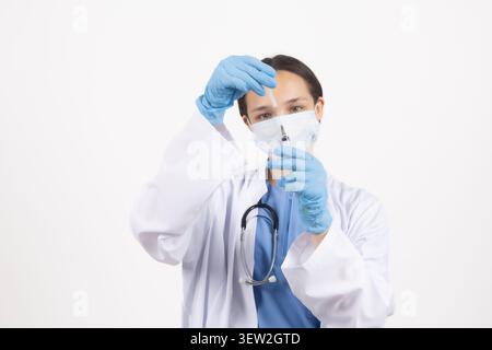Scientist looking through a magnifying glass and examining something very carefully Stock Photo