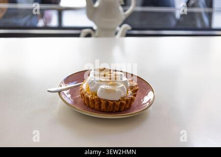 Lemon meringue tart on a pink plate Stock Photo