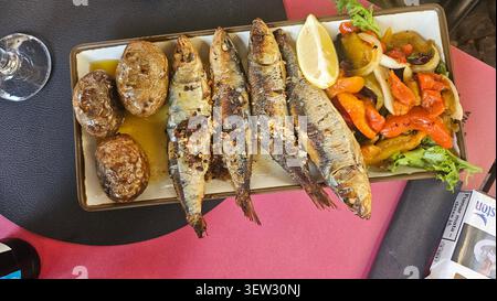 Traditional Portuguese Sardinhas Assadas with Roasted Potatoes and Peppers Stock Photo
