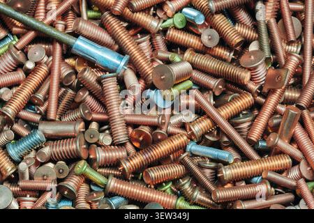 Industrial textured background and many metal fastening bolts screws Stock Photo
