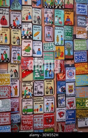 Marrakech, Morocco - 03 December 2017: A close-up, full-frame shot of numerous colorful, hand-painted wooden or ceramic plaques, likely souvenirs, dis Stock Photo