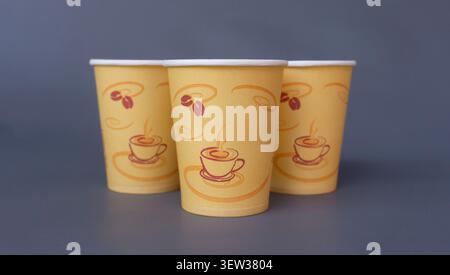 Three Disposable Coffee Paper Cups on Dark Gray Background Stock Photo