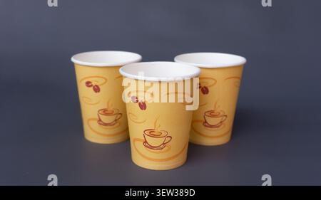 Three Paper Coffee Cups on Gray Background Stock Photo