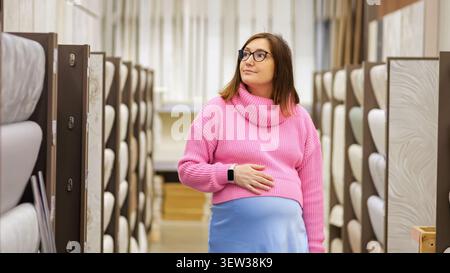 Pregnant woman choosing materials for home renovation Stock Photo