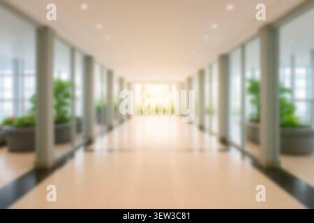 Blurred luxury hotel lobby with grand chandelier, warm lighting, and marble floor. Elegant hospitality and interior design mockup background. Stock Photo