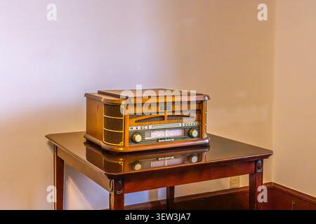 Vintage tabletop radio displayed on a wooden table in Nagasaki, Japan. Stock Photo