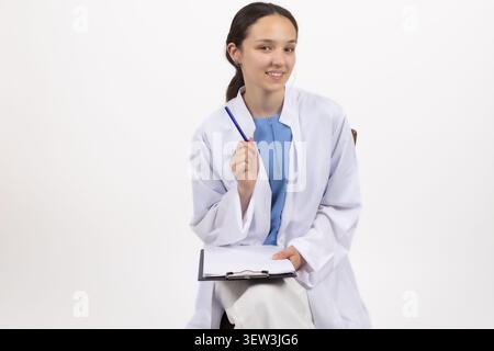 Professional female medical doctor posing inside studio environment Stock Photo