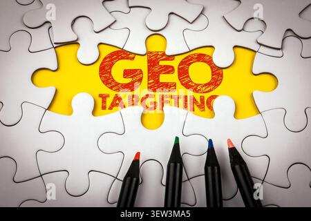 GEO TARGETING Text on Puzzle Pieces Representing Location Based SEO Marketing Strategy Stock Photo