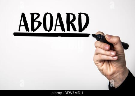ABOARD text being written with marker showing start of journey or participation idea Stock Photo