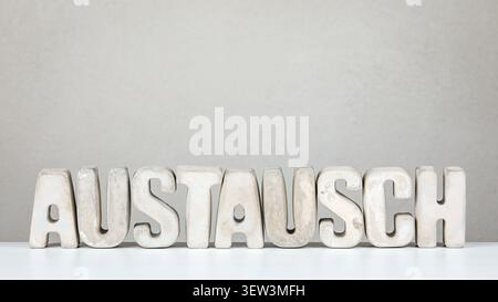 Exchange From German Word AUSTAUSCH Displayed With Solid Letters In Clean Neutral Scene Stock Photo