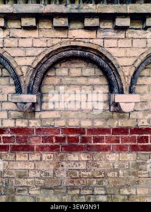 Decorative brick arches and masonry detail on a staircase wall inside the Royal Academy of Arts in London Stock Photo