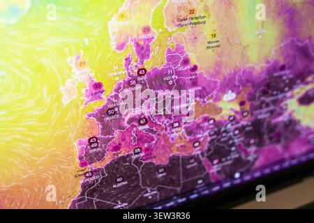Close-up of a digital weather map displaying extreme heatwave temperatures across Europe, symbolizing global warming, climate change, and anomalous su Stock Photo