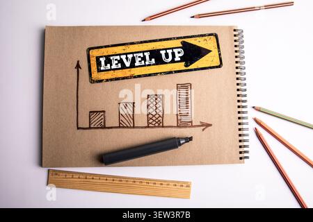 LEVEL UP text with hand drawn chart showing improvement growth and performance increase Stock Photo