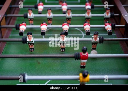 Close-up of a classic table football game with miniature players on a green pitch Stock Photo