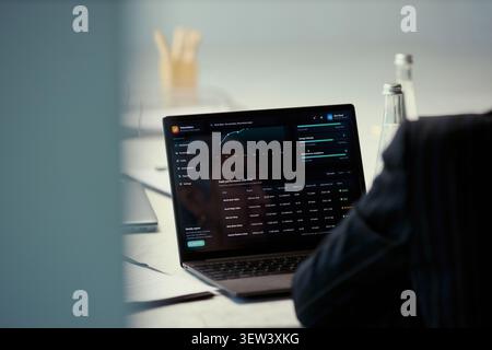 Close up of business professional reviewing oil field performance dashboard on laptop during meeting, analyzing production data and strategy. Ideal for energy analytics or corporate reporting Stock Photo