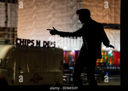 The statue on Liverpool Waterfront of singer Billy Fury, by night Stock Photo
