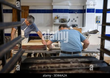 Bakers preparing bread dough in a professional kitchen Stock Photo