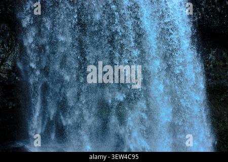 Rushing Curtain - A Close-Up Perspective of Churning Blue and White Water Cascading Down a Cliff Face Stock Photo