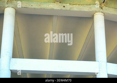Bright white columns and beams create a striking view from below the ceiling. Stock Photo