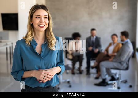 Multicultural professional businesspeople working together on research plan in boardroom. Stock Photo