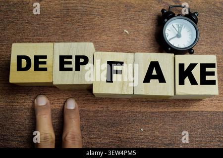 Concept of deep fake text on wooden blocks. Stock Photo