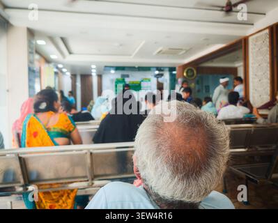 Patients and families wait in the maternity hospital lobby in India, reflecting everyday healthcare, hope and the journey toward new life. Stock Photo