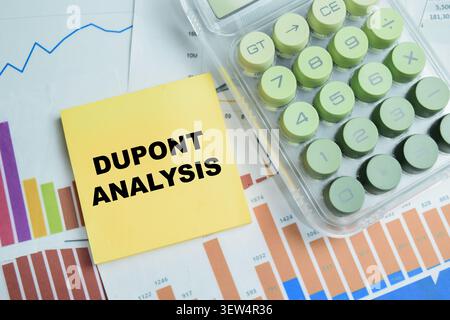 Concept of Dupont analysis write on sticky notes isolated on Wooden Table. Stock Photo