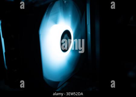 Detail of professional gaming PC interior. Motherboard, CPU tower cooler, graphics card, and RAM with colorful RGB LED lights. Stock Photo