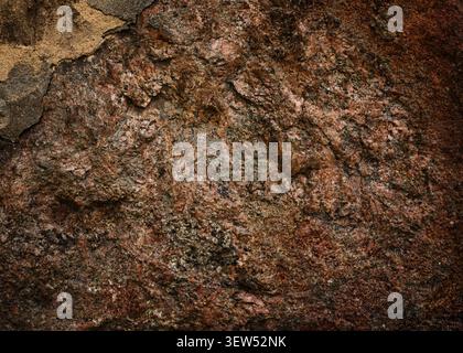 Rough natural red granite stone wall texture background Stock Photo