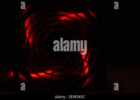 Detail of professional gaming PC interior. Motherboard, CPU tower cooler, graphics card, and RAM with colorful RGB LED lights. Stock Photo