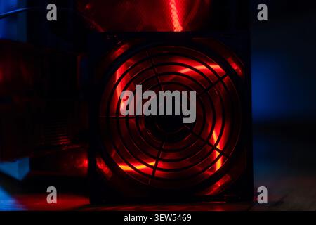 Detail of professional gaming PC interior. Motherboard, CPU tower cooler, graphics card, and RAM with colorful RGB LED lights. Stock Photo