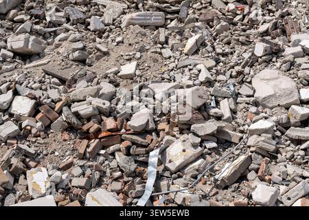 pile of rubble containing broken red bricks and fragmented concrete blocks from a destroyed building Stock Photo