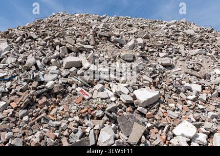 pile of rubble containing broken red bricks and fragmented concrete blocks from a destroyed building Stock Photo