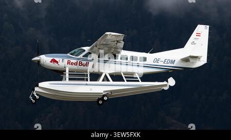Red Bull Cessna 208 Caravan Amphibian seaplane in flight over the Austrian Alps Stock Photo
