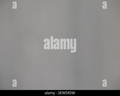 A light gray matte texture with a soft, subtle vertical gradient. The smooth, uniform surface resembles a painted wall, clean concrete, or thick paper Stock Photo