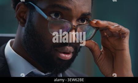 Close up African American business man in glasses looking at computer monitor working businessman male guy professional executive agent wearing Stock Photo